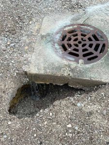 broken drain and grate causing poor ground drainage